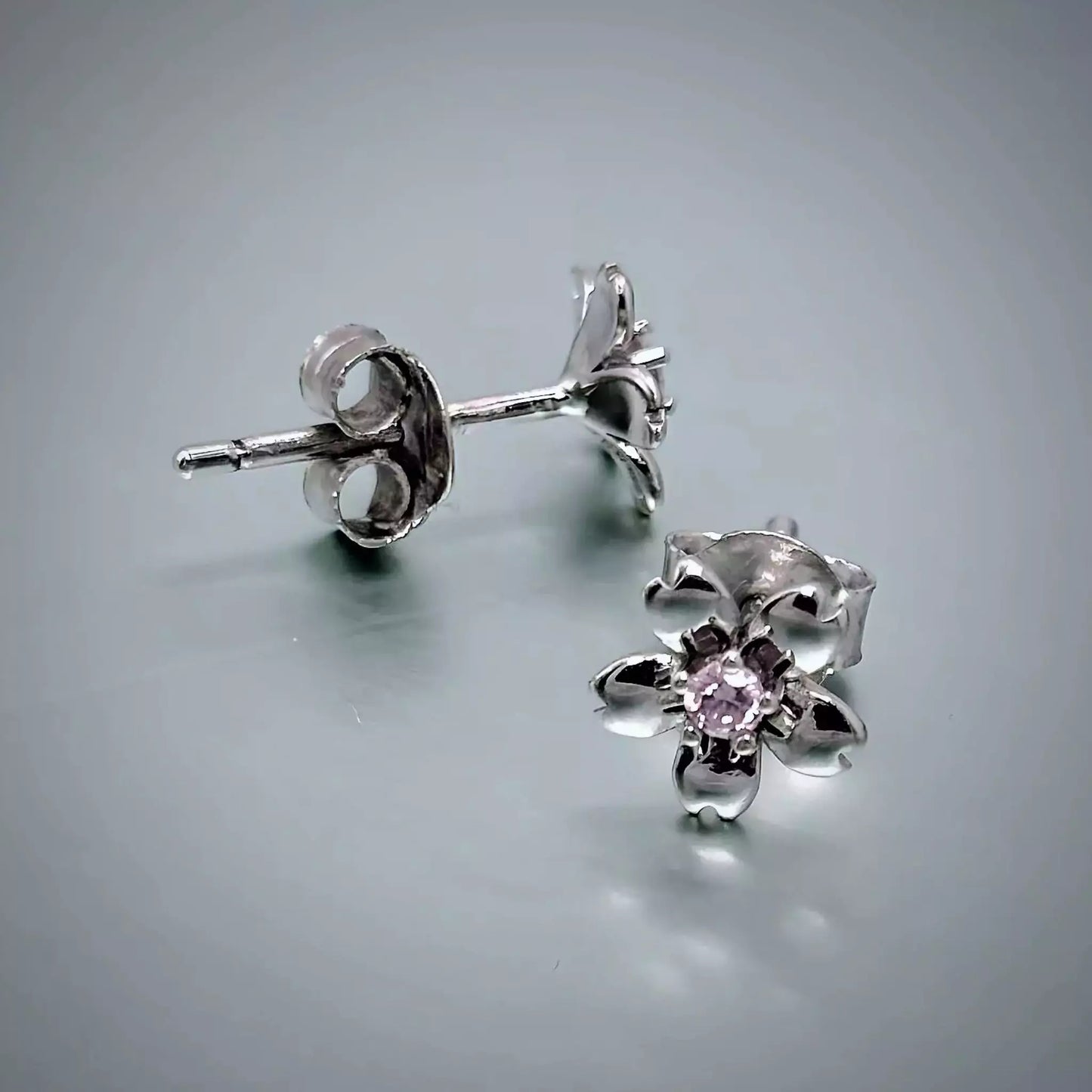 A pair of small Sterling Silver Pink Flower Studs Earrings , 5 petals, pink cubic zirconia centre stone and butterfly backiings