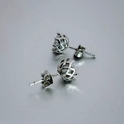 A pair of round stud earrings crafted in Sterling Silver 925,  with clear  Cubic Zirconia placed on a grey background.