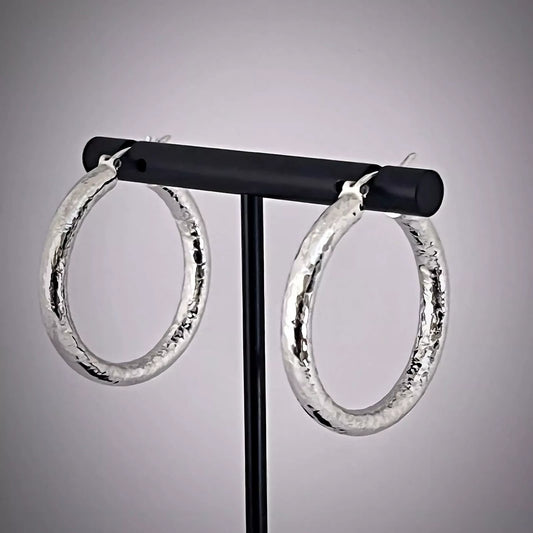 Creole Hoop Earrings crafted in  Sterling Silver 925 Hammered texture on black t-bar earring stand.