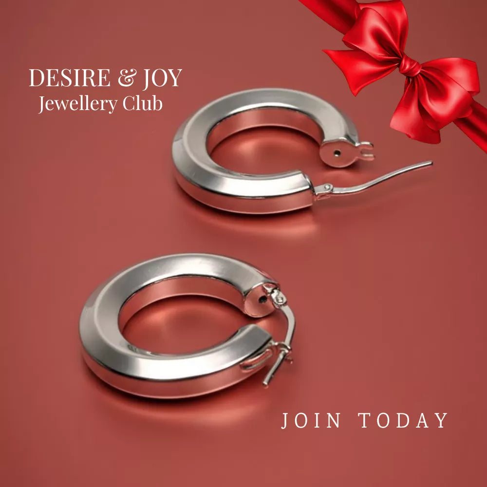 Silver hoop earrings displayed on a warm red surface with a red ribbon bow, shown with the text “Desire & Joy Jewellery Club” and “Join Today” to promote exclusive member benefits.