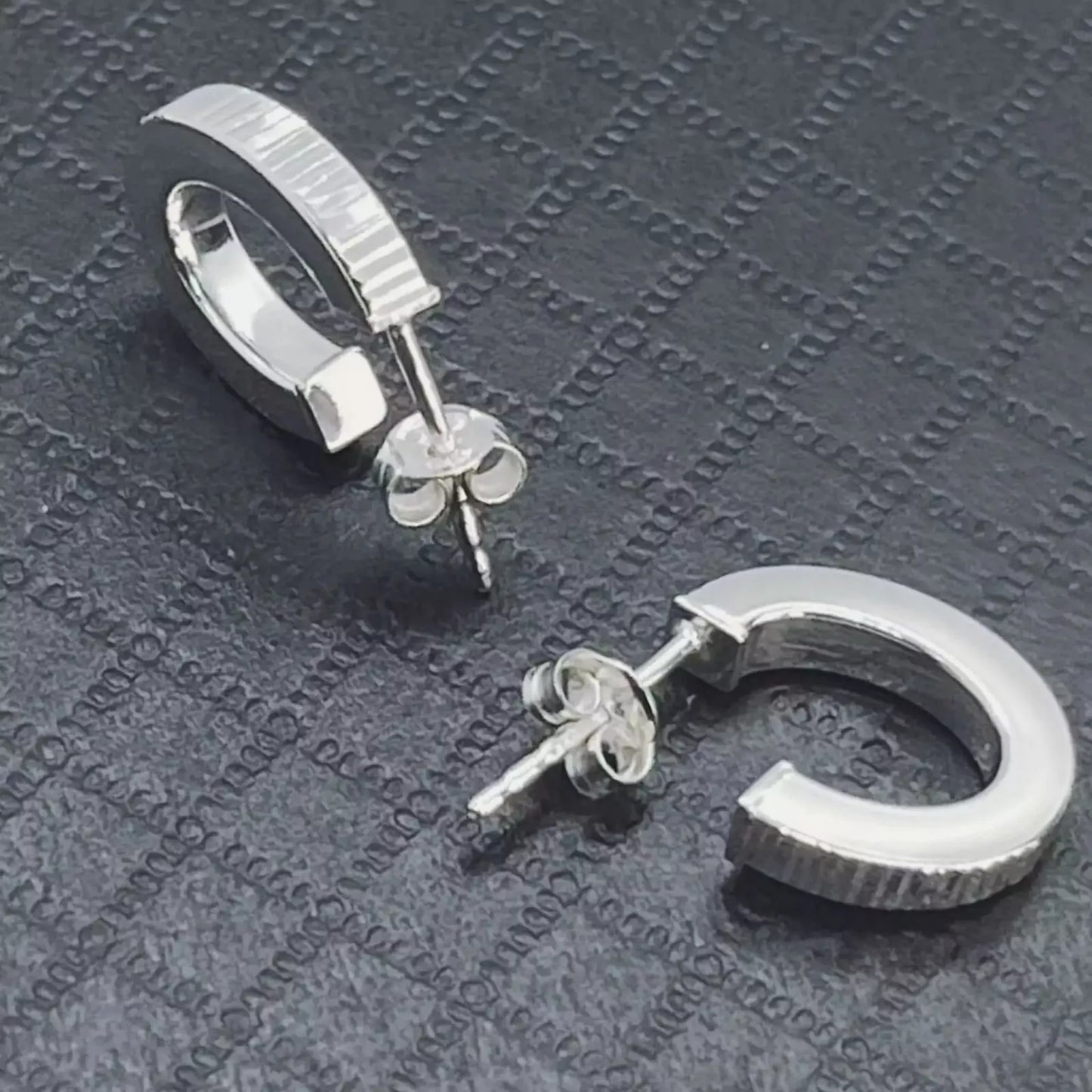 Stunning Ribbed Lobe Hoop Sterling Silver 925 Earrings on textured black surface.
