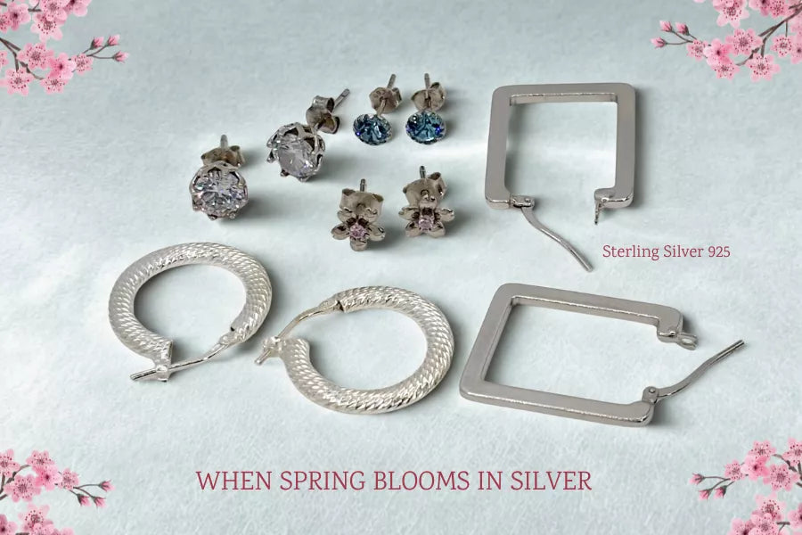 Sterling silver earrings, 925 Jewellery Aesthetic featuring cubic zirconia stud earrings, creole hoop earrings and geometric hoop earrings displayed on a spring-blue background with spring-blossom florals.