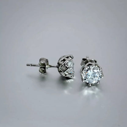 A pair of silver stud earrings crafted in sterling silver 925 features clear cubic zirconia gems on a light grey background.