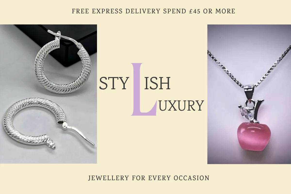 Sterling silver 925 textured creole hoop earrings and a silver 925 necklace with a pink apple pendant and cubic zirconia leaf displayed on a soft vanilla background.