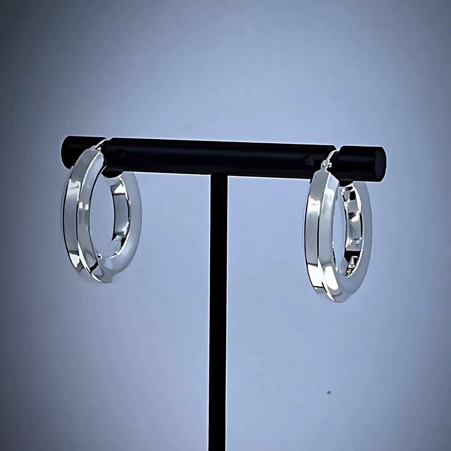 A pair of Chunky Sterling Silver 925 Hoop Earrings, tube-shaped Hexagon placed on a black background.