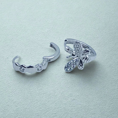 Sterling Silver Huggie Hoops Asymmetric design, bee earring and open honeycomb earring  on a light background