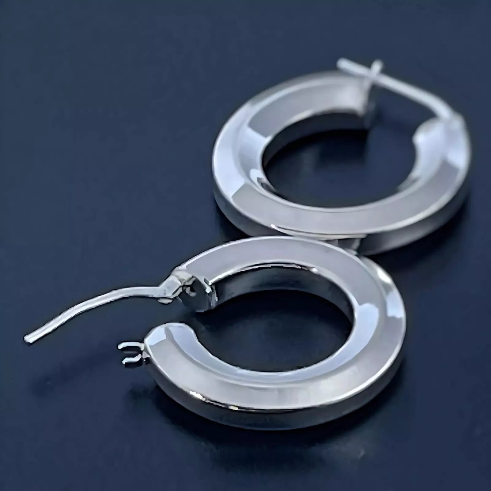 Chunky Sterling Silver 925 Hoop Earrings tube-shape Hexagon placed on a black background.