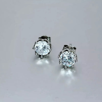 A pair of Cubic Zirconia Earrings crafted in Sterling Silver 925,  round clear stone on a grey background.